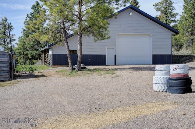 view of side of property featuring an outbuilding and a garage