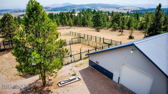 birds eye view of property featuring a mountain view and a rural view
