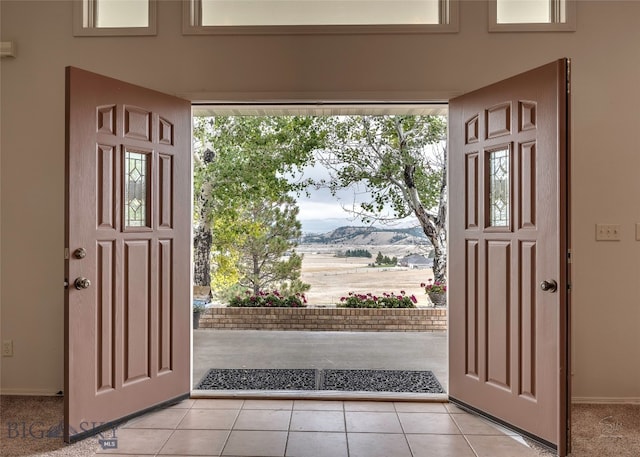 tiled entrance foyer with a mountain view