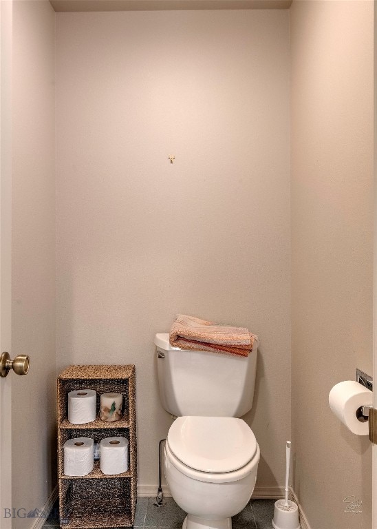 bathroom with tile patterned flooring and toilet