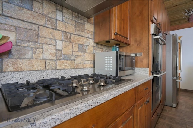 310 Highpark Dr, Anaconda, MT 59711 - kitchen with stainless steel appliances, brown cabinetry, light countertops, and dark wood-type flooring