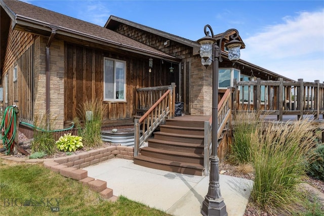 310 Highpark Dr, Anaconda, MT 59711 - doorway to property with stone siding and a shingled roof
