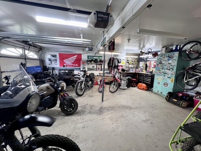 garage with a garage door opener and a workshop area