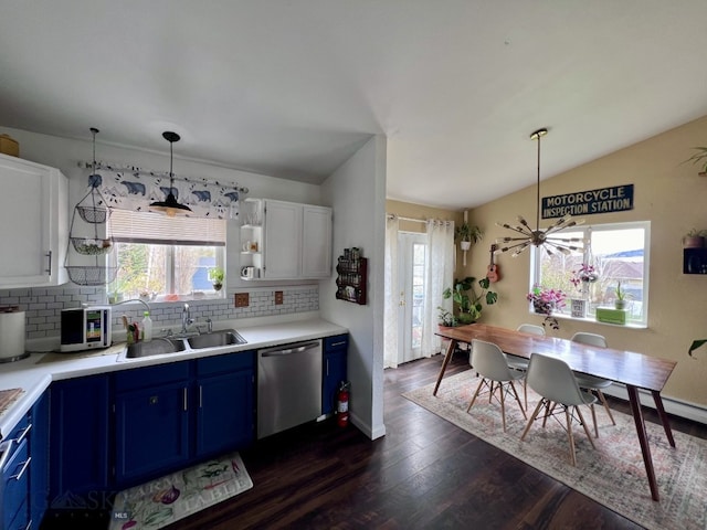 kitchen featuring blue cabinets, white cabinetry, stainless steel appliances, and a wealth of natural light