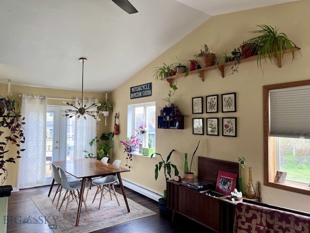 dining area with dark hardwood / wood-style floors, vaulted ceiling, baseboard heating, and a wealth of natural light