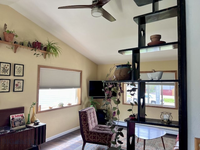 office area featuring ceiling fan, hardwood / wood-style flooring, baseboard heating, and vaulted ceiling