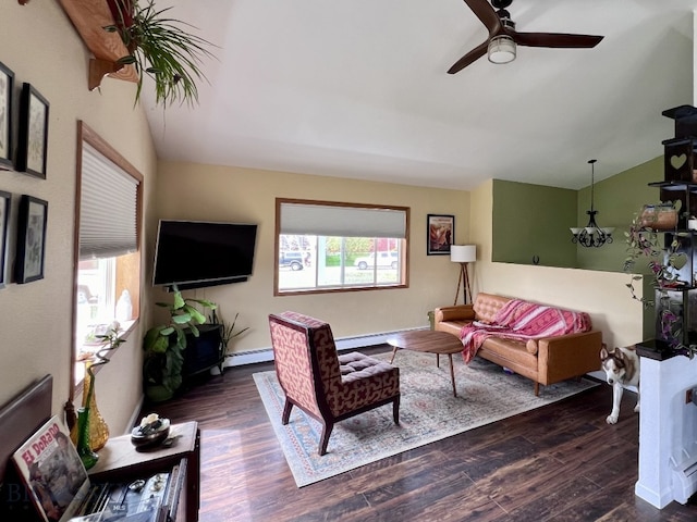 living room with vaulted ceiling, plenty of natural light, and dark hardwood / wood-style flooring