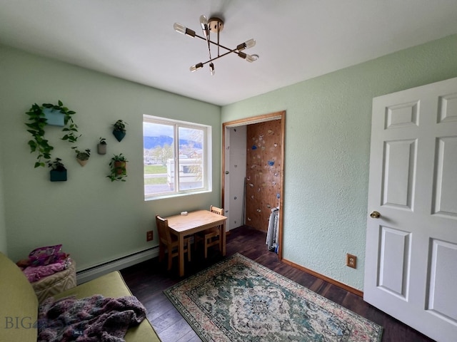 bedroom featuring a notable chandelier, baseboard heating, and dark hardwood / wood-style flooring