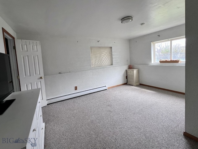 spare room featuring light colored carpet and a baseboard radiator