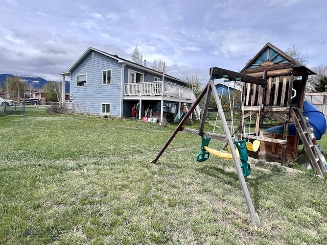 view of jungle gym with a yard and a deck