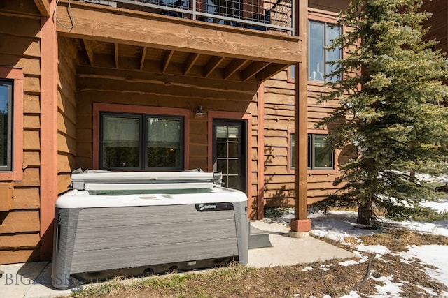 exterior space featuring a balcony and a hot tub