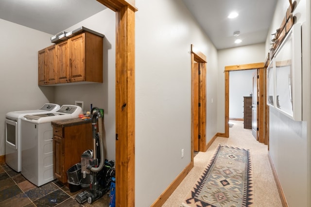 laundry room featuring separate washer and dryer, cabinets, and dark colored carpet