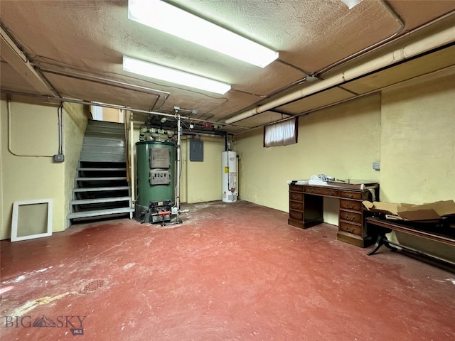 basement featuring gas water heater, a textured ceiling, and electric panel