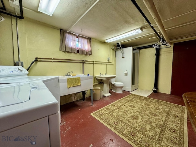 clothes washing area with sink and washer and dryer