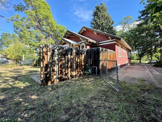 view of side of home with a yard