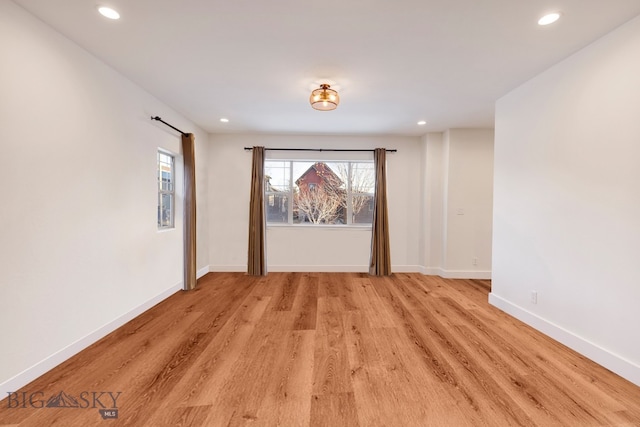 empty room with light hardwood / wood-style flooring