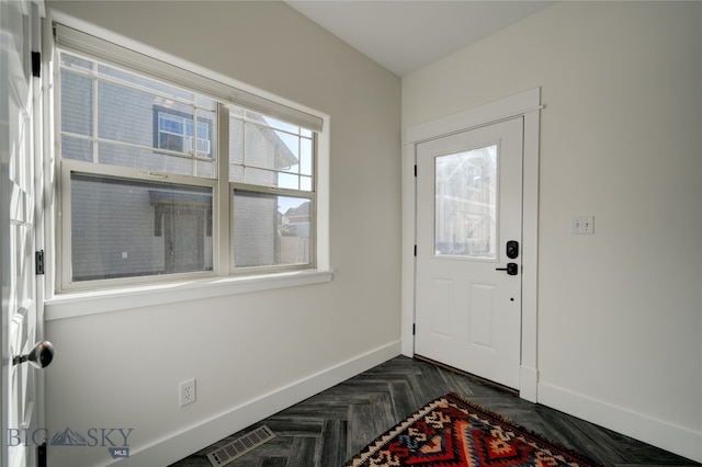 entrance foyer featuring dark parquet flooring