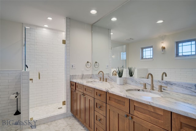 bathroom featuring tile walls, vanity, tile patterned floors, and an enclosed shower