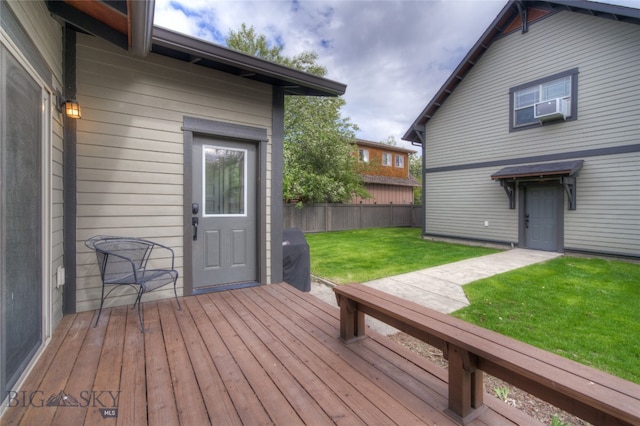 wooden terrace featuring cooling unit and a yard