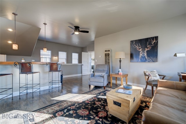 living room with ceiling fan and dark hardwood / wood-style floors