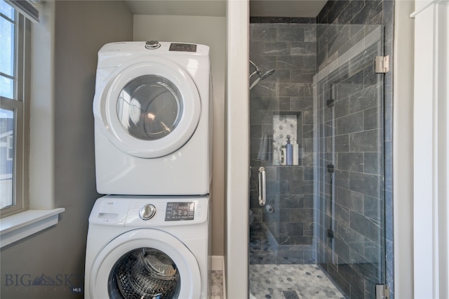 laundry area with stacked washer / drying machine