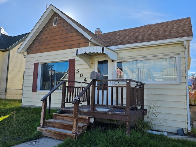 back of property featuring a wooden deck