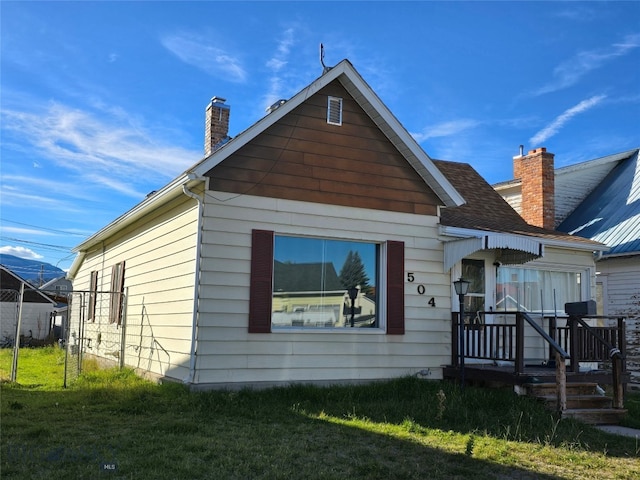 view of front of property with a front yard and a deck