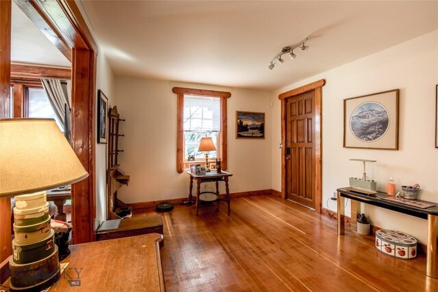 foyer entrance featuring hardwood / wood-style flooring and rail lighting