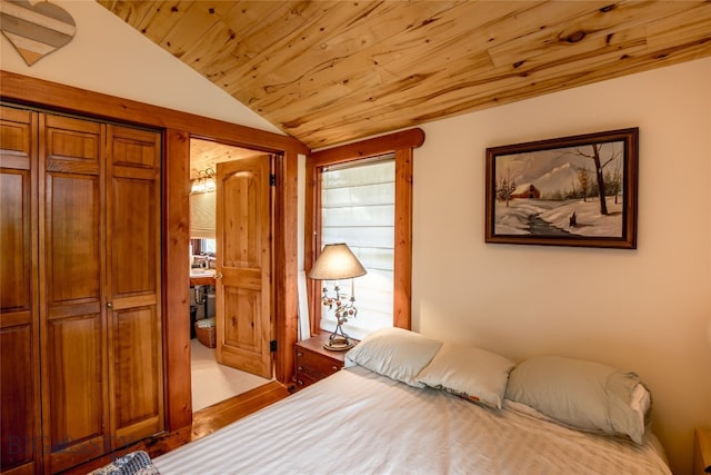 bedroom with wood ceiling, a closet, and lofted ceiling