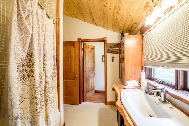 bathroom featuring lofted ceiling, wooden ceiling, and vanity