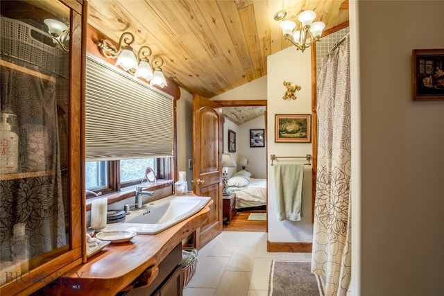 bathroom with wood ceiling, vaulted ceiling, vanity, tile patterned floors, and an inviting chandelier