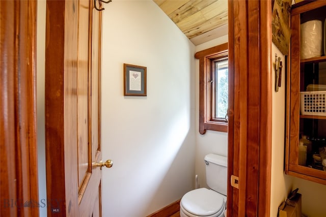 bathroom with lofted ceiling, toilet, and wood ceiling