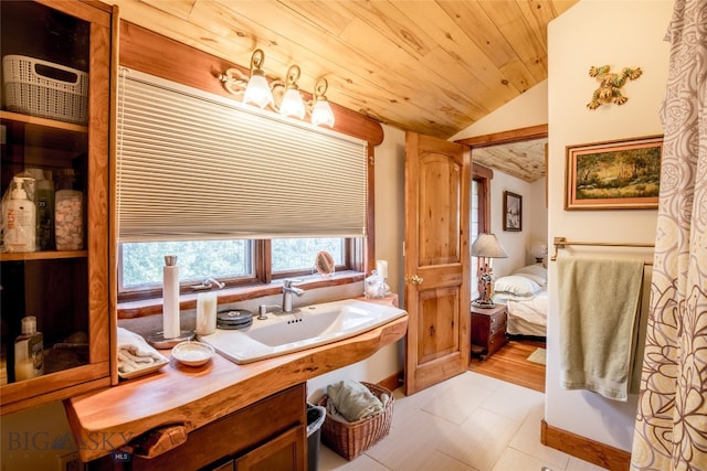 bathroom featuring lofted ceiling, tile patterned flooring, sink, and wooden ceiling