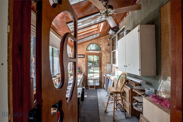 miscellaneous room with lofted ceiling, ceiling fan, and a healthy amount of sunlight