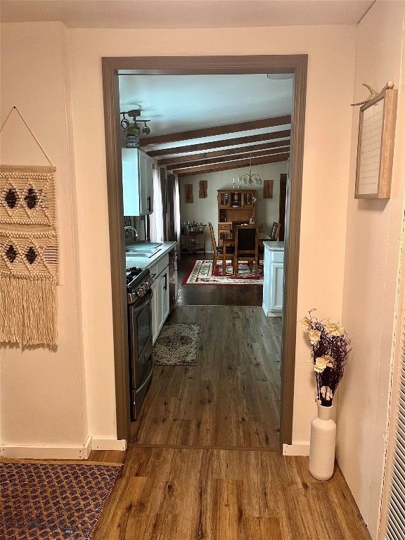 hall with lofted ceiling, sink, and dark hardwood / wood-style flooring