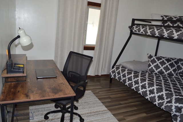 bedroom with dark hardwood / wood-style floors