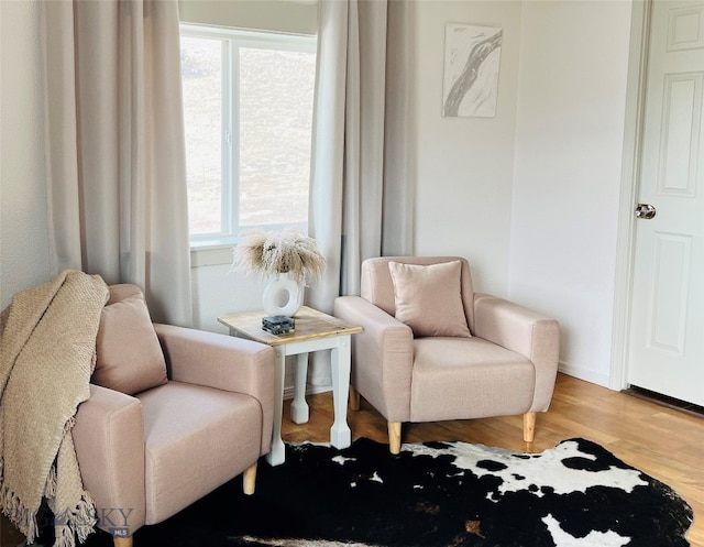 sitting room with wood-type flooring