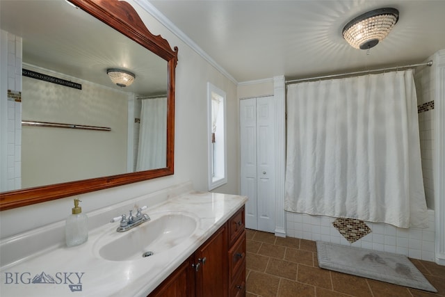 bathroom featuring ornamental molding, vanity, and tile patterned floors