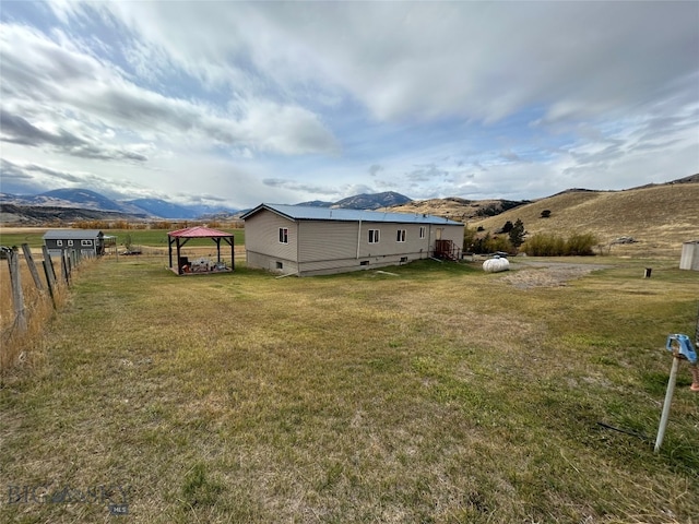 view of yard featuring a rural view, a mountain view, and a gazebo