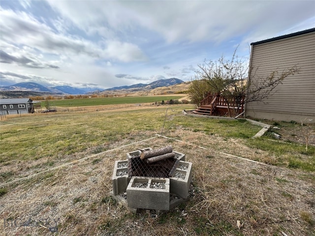 view of yard with a rural view and a mountain view