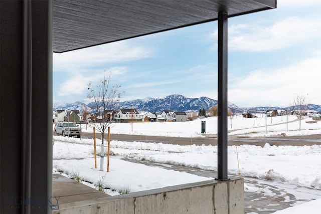 yard covered in snow with a mountain view