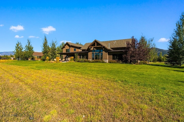 exterior space with a mountain view and a front yard