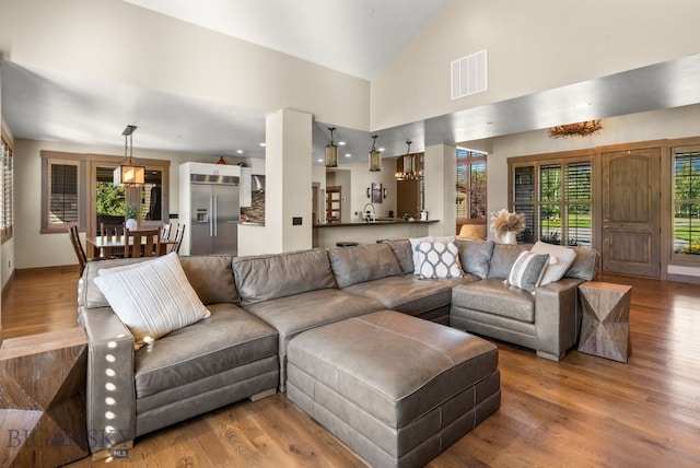 living room featuring hardwood / wood-style floors and high vaulted ceiling