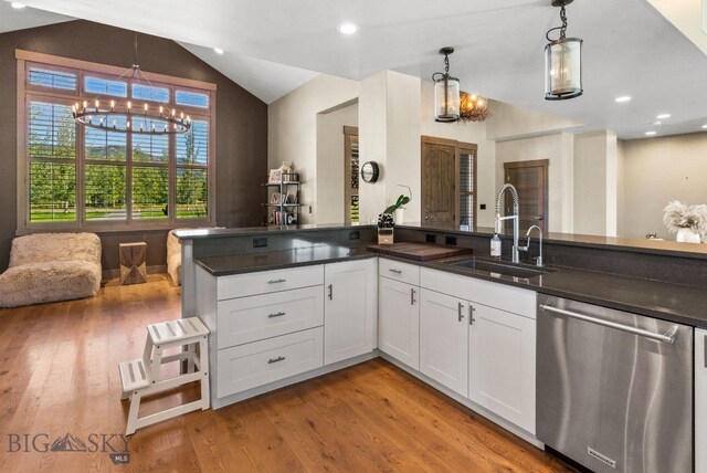 kitchen featuring white cabinets, dishwasher, pendant lighting, and sink