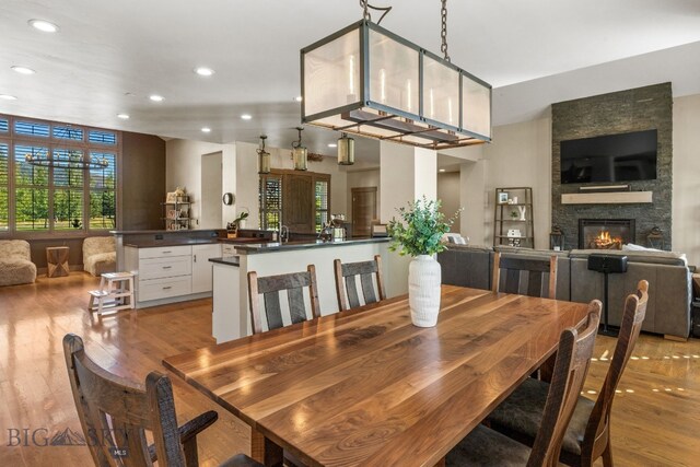 dining room featuring a fireplace and light wood-type flooring