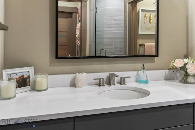 bathroom featuring vanity and a shower with door