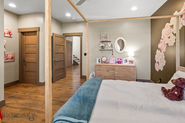 bedroom featuring dark hardwood / wood-style flooring and ceiling fan