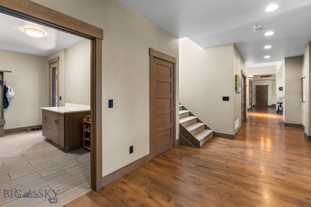 corridor with light hardwood / wood-style flooring