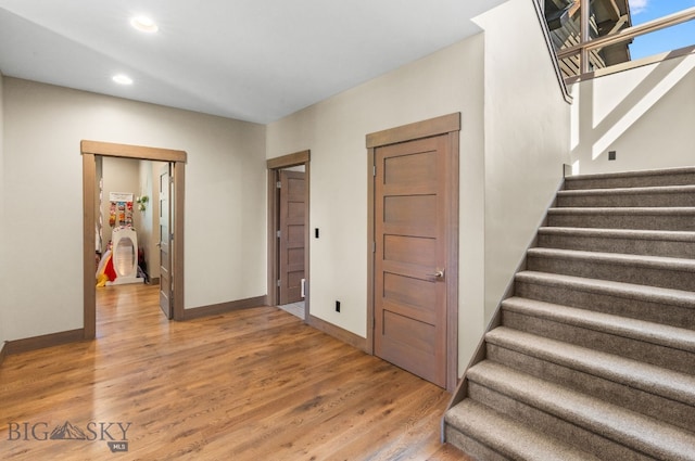 stairs with hardwood / wood-style flooring