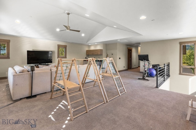 living room featuring ceiling fan, light colored carpet, and vaulted ceiling